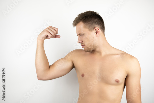image of handsome fit confident man with naked torso showing biceps muscles white isolated background