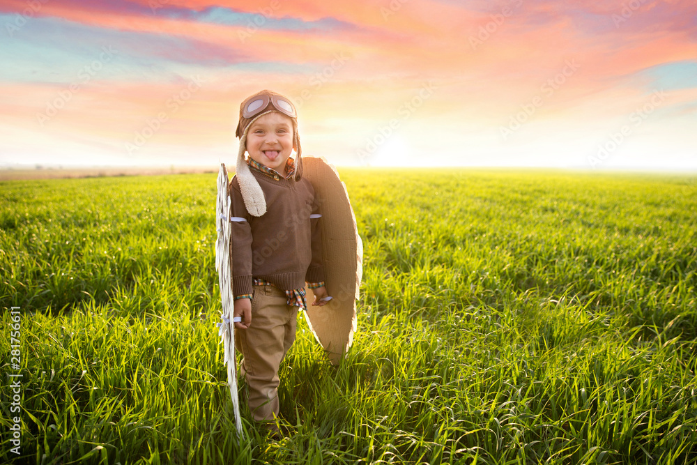 happy smile kid in green grass field on sunrise prepare flight in freedom sky in his dream happy smile kid in green grass field on sunrise prepare flight in freedom sky in his dream