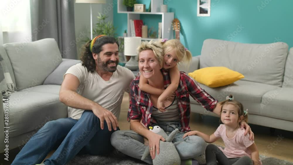 Dad turns on timer on camera for family photo at home Dad turns on timer on camera for family photo at home