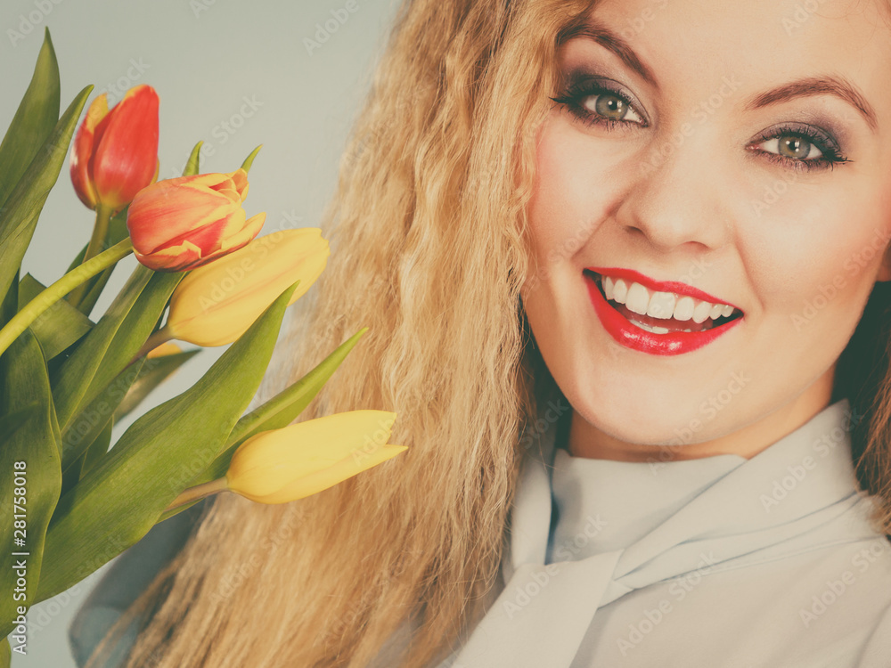 Pretty woman with red yellow tulips bunch Pretty woman with red yellow tulips bunch