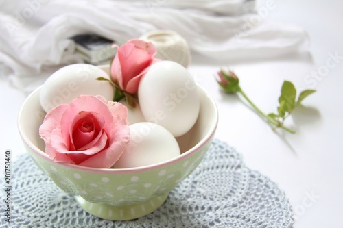 Pink rose and eggs in the bowl 