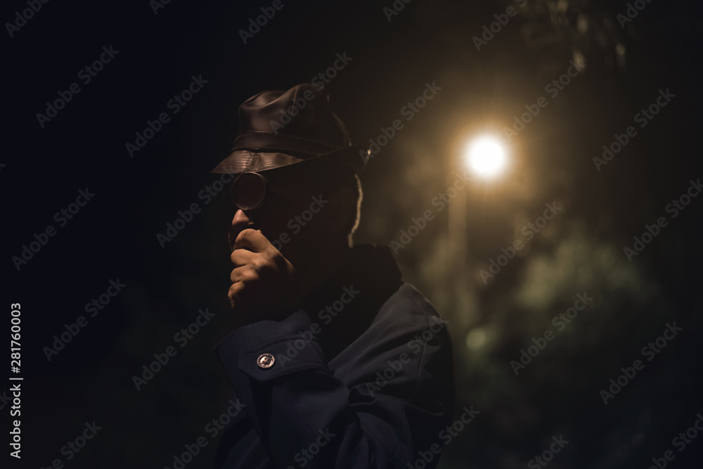 Detective agent is watching through a magnifying glass and searching for evidences. Detective agent is watching through a magnifying glass and searching for evidences.