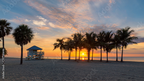 Fototapeta Naklejka Na Ścianę i Meble -  Sunrise at palm trees by the ocean beach in Key Biscayne, Florida