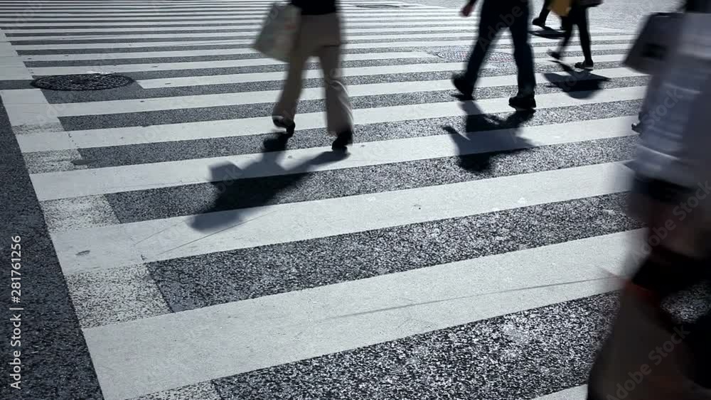 Low section view of pedestrians and cyclists crossing street, Japan Low section view of pedestrians and cyclists crossing street, Japan