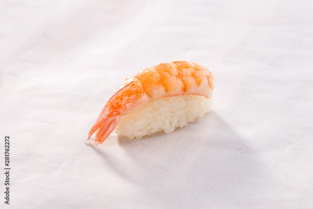 Shrimp sushi Ebi Nigiri on white crumpled paper background Shrimp sushi Ebi Nigiri on white crumpled paper background