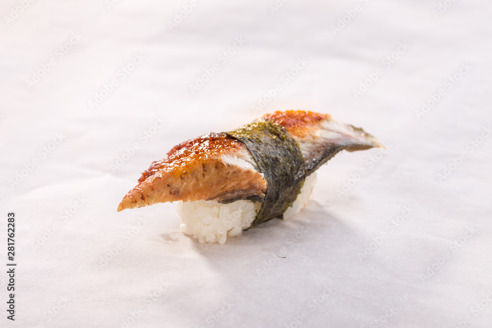 Unagi sushi with eel and rice on white crumpled paper background Unagi sushi with eel and rice on white crumpled paper background
