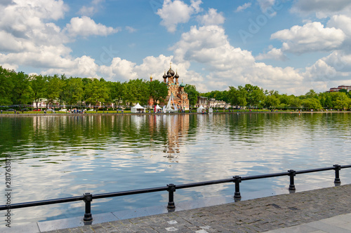 Ostankinskiy pond in Moscow on a background of blue sky with white clouds in sunny morning photo