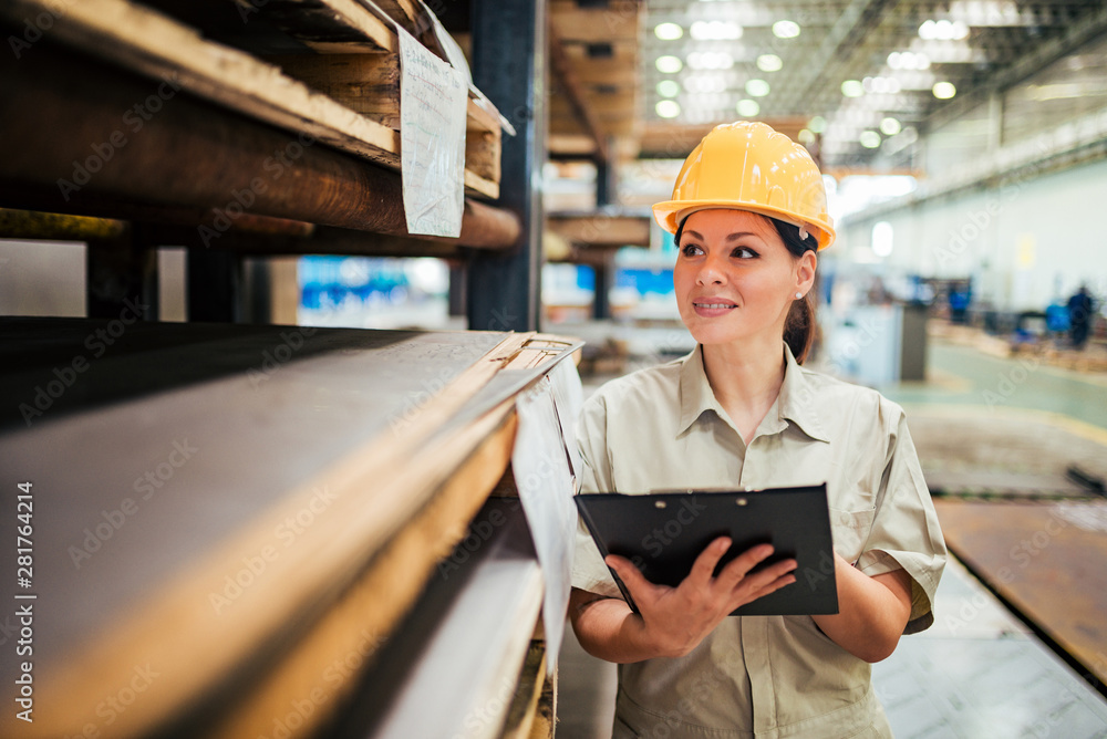 Portrait of a beautiful female worker at the factory warehouse. Portrait of a beautiful female worker at the factory warehouse.