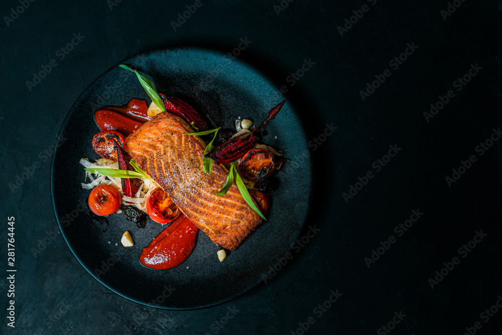 Delicious meal on a black plate, top view, copy space. - obrazy, fototapety, plakaty 