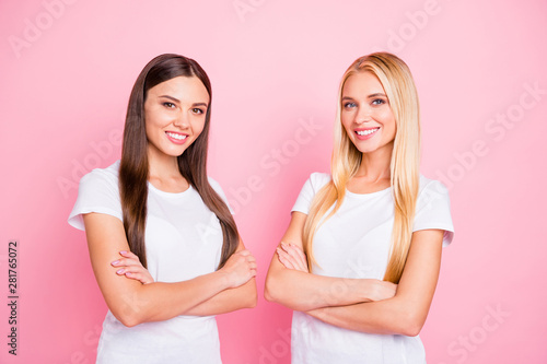 Photo of two pretty ladies crossing arms wear casual outfit isolated pink background