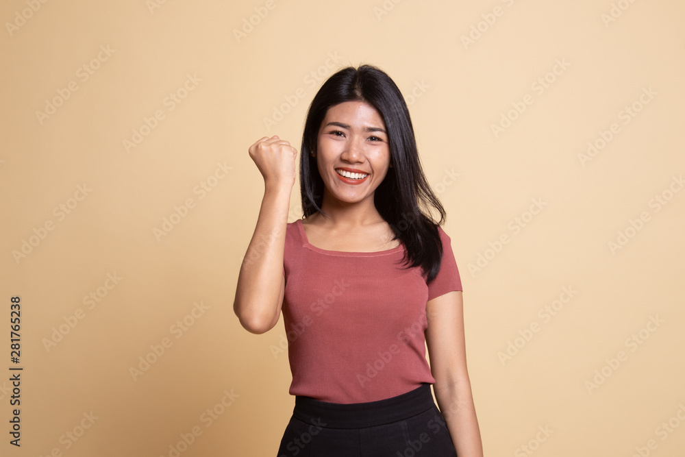 Successful young Asian woman hold fist up. Successful young Asian woman hold fist up.