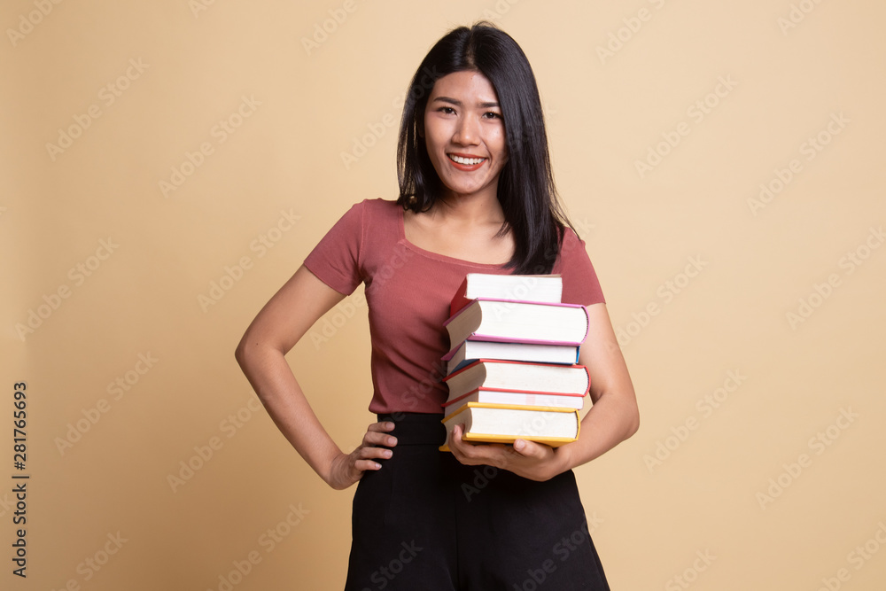 Young Asian woman studying with may books. Young Asian woman studying with may books.