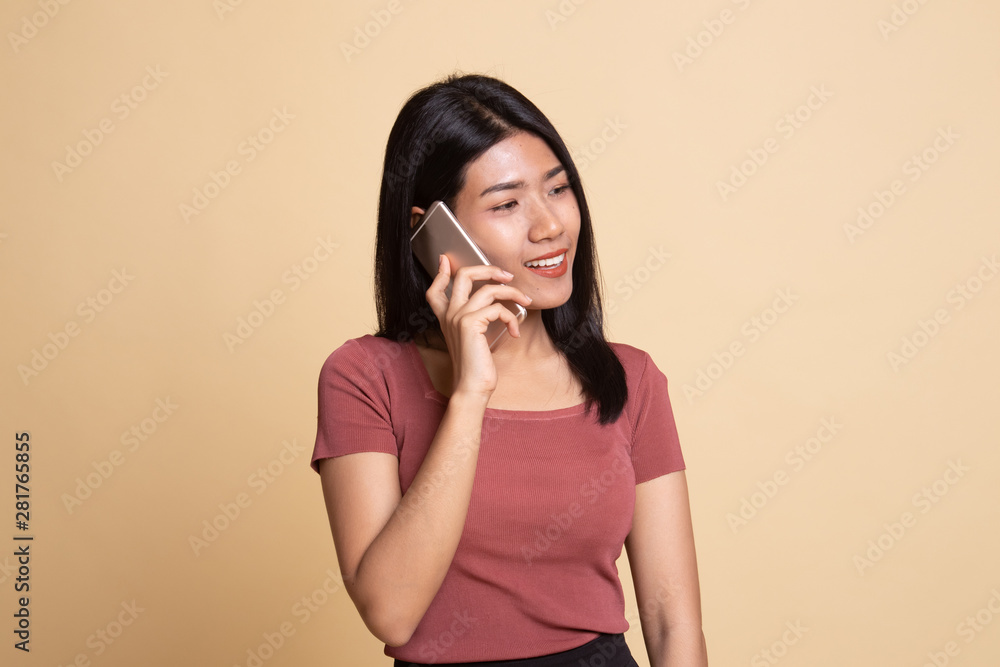 Young Asian woman talking with mobile phone. Young Asian woman talking with mobile phone.