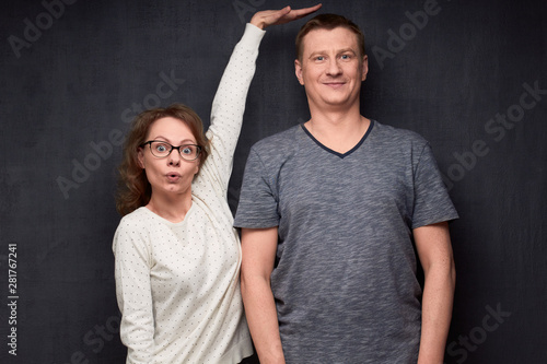 Shot of funny short woman and tall man photo