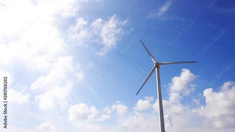 Wind turbine against blue sky and clouds, Japan Wind turbine against blue sky and clouds, Japan