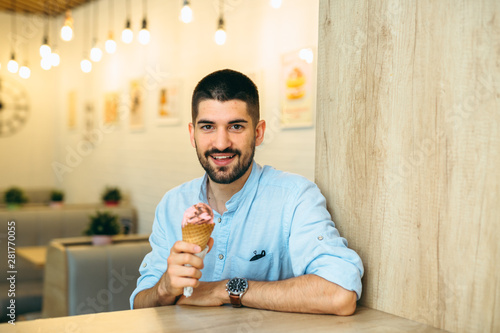 man eating ice cream in cone indoor