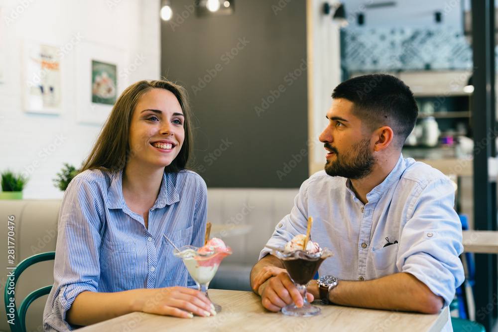 happy couple eating ice cream in candy shop happy couple eating ice cream in candy shop