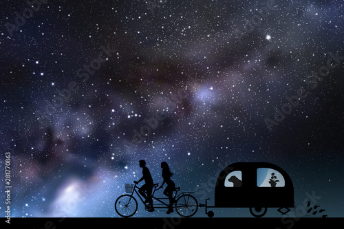 Newlyweds on bike tandem on road at night. Vector illustration with silhouettes of people and dog traveling with camper trailer. Family road trip. Space dark background with starry sky and Milky Way