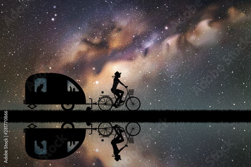 Girl on bicycle on road at night. Vector illustration with silhouettes of cyclist and pet traveling with camper trailer. Family road trip. Space dark background with starry sky and Milky Way © arvitalya