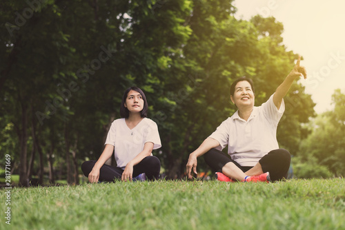 Asian women hands pointing something and relax at public park in the morning together,Happy and smiling,Positive thinking,Healthy and lifestyle concept