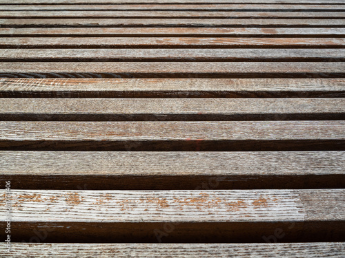Wooden bench in the Park. the texture of the bench. Sticks stacked in a row