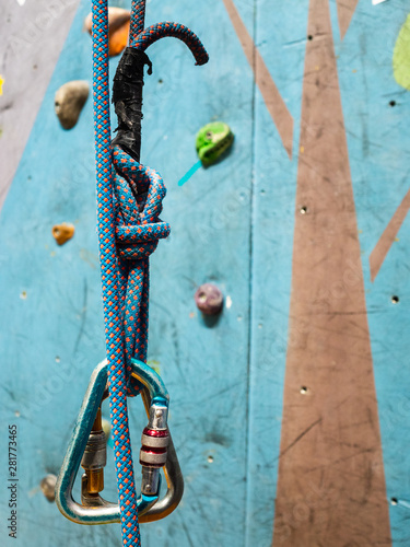 Carabiner and a strong rope in training for climbing. Climbing wall with obstacles photo