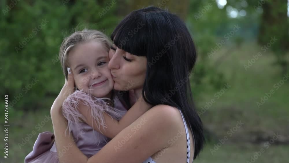 beautiful young mother holding daughter, hugs and tenderness, slow motion, family and love concept beautiful young mother holding daughter, hugs and tenderness, slow motion, family and love concept