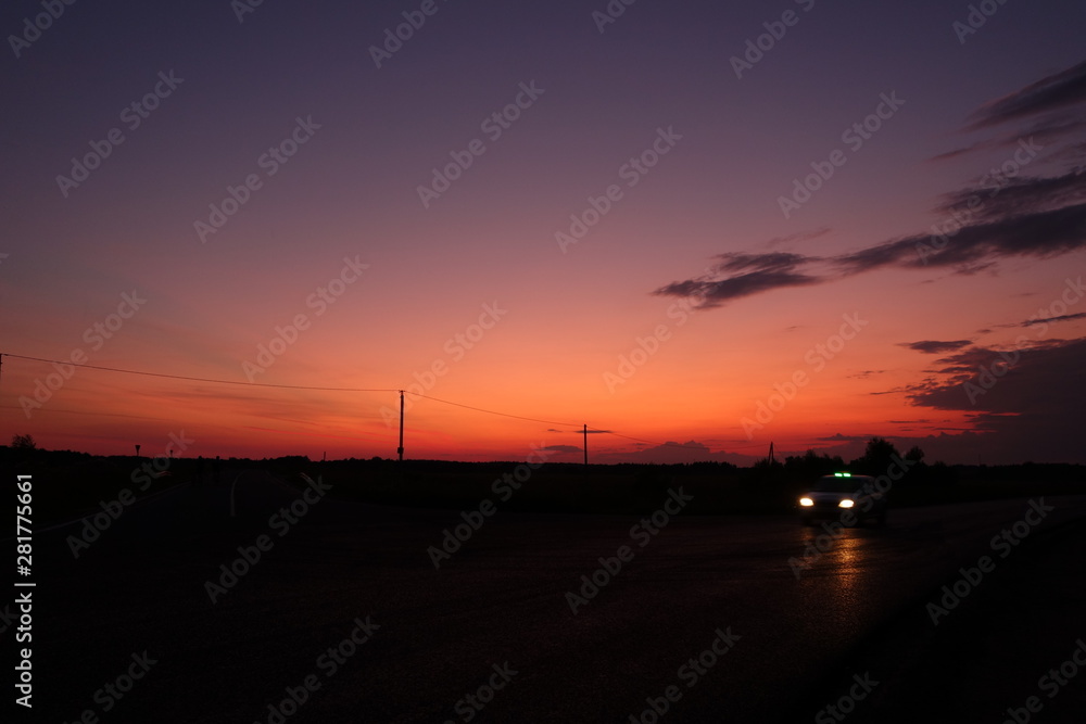 Sunset noir in red with car headlights and taxi light in black foreground
