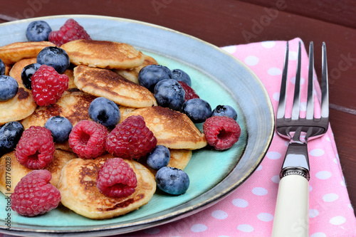 Delicious pancakes with berries and maple syrup