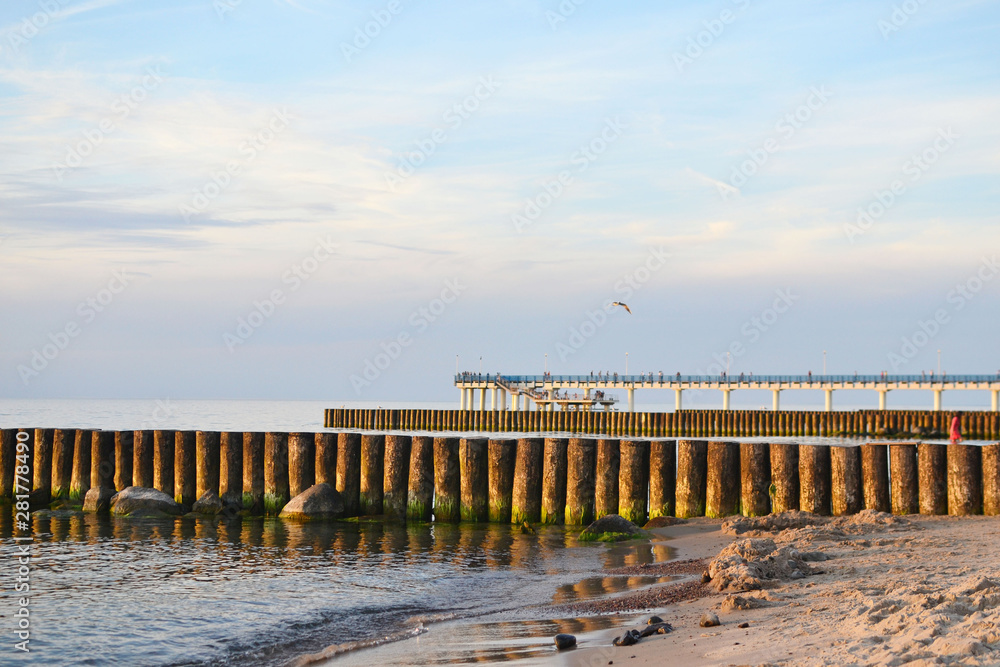 Baltic sea beach with views of breakwaters and pier