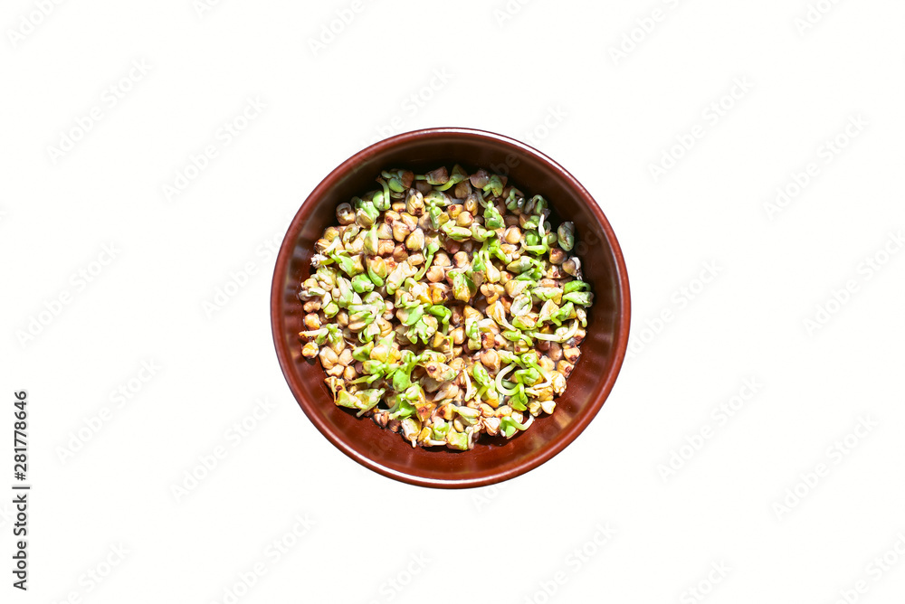 Brown bowl of sprouted green buckwheat on white background. Vegetarianism. Vitamins. Fagopyrum Brown bowl of sprouted green buckwheat on white background. Vegetarianism. Vitamins. Fagopyrum