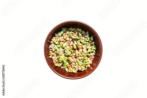 Brown  bowl of sprouted green buckwheat on white background. Vegetarianism. Vitamins. Fagopyrum