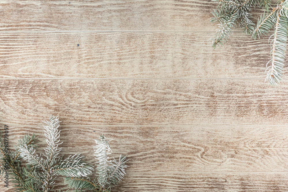 Christmas tree branch with pine cones on rustic wooden table. Winter