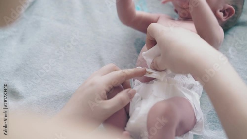 Wallpaper Mural careful mother hands practice newborn baby umbilical cord care on lying infant boy extreme close view Torontodigital.ca