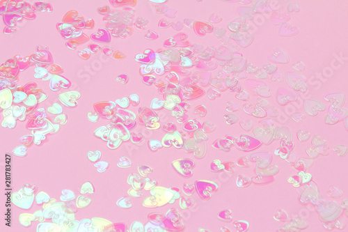 Heart holographic confetti sparkles on pink background