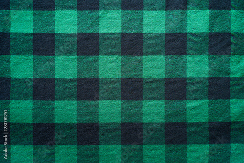 Fabric in a cage. Black and green square pattern. Clothes Empty Background