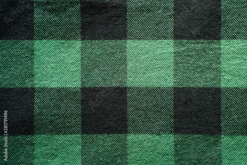 Fabric in a cage. Black and green square pattern. Clothes Empty Background