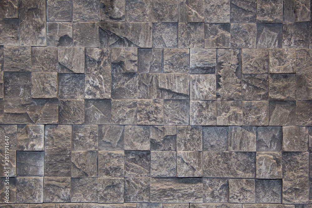 The wall of natural stone untreated. Decorative stone. Black stone background.