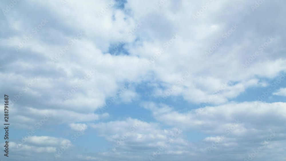 Timelapse of white clouds flowing against blue sky on sunny day Timelapse of white clouds flowing against blue sky on sunny day