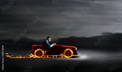 Businessman in a red car with flames
