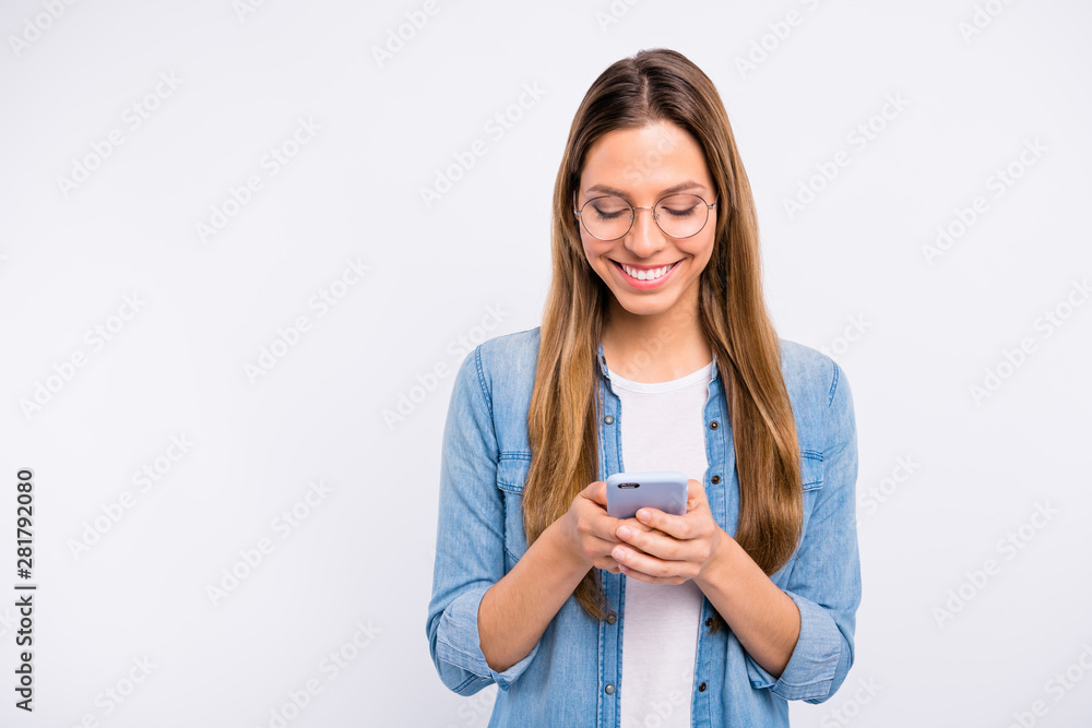 Photo of charming attractive nice glad lady with beaming smile holding new telephone in hands isolated grey background Photo of charming attractive nice glad lady with beaming smile holding new telephone in hands isolated grey background