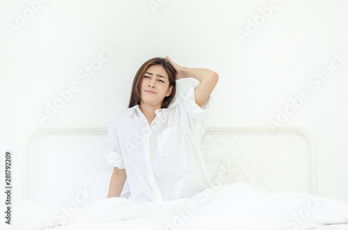 women sit at the edge of the bed.