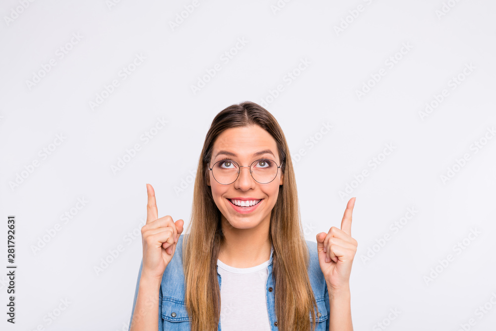 Close up photo portrait of cheerful excited nice glad positive lady demonstrating empty copy space over head isolated grey background Close up photo portrait of cheerful excited nice glad positive lady demonstrating empty copy space over head isolated grey background