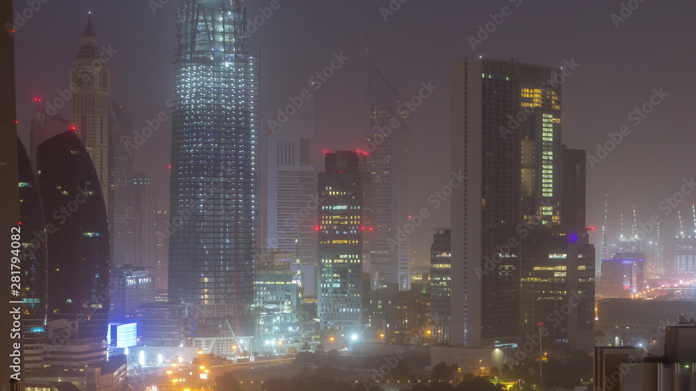 Dubai downtown skyline night to day aerial timelapse with traffic on highway