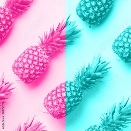 Fotografie Fresh pineapples on trendy neon pink and blue color background