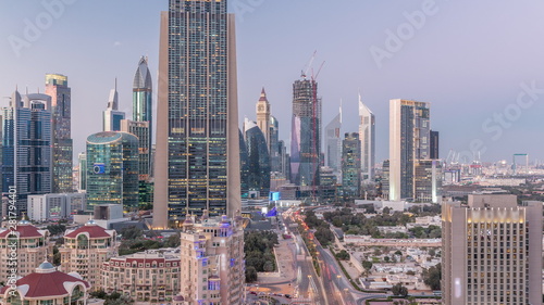 Skyline view of the buildings of Sheikh Zayed Road and DIFC day to night timelapse in Dubai, UAE. © neiezhmakov