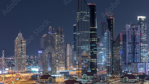 Aerial view of illuminated skyscrapers and road junction in Dubai timelapse