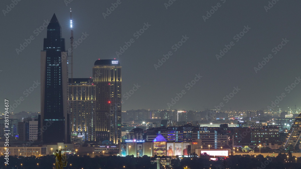 Dubai skyline over the Healthcare City and pyramid illuminated at night timelapse in Dubai, UAE