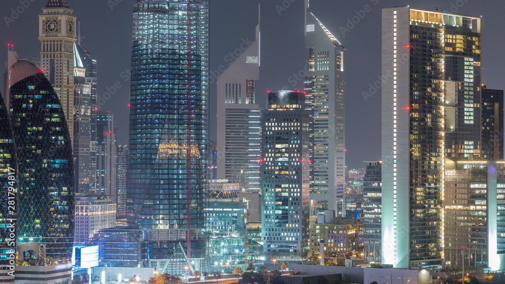 Aerial view on downtown and financial district in Dubai night timelapse, United Arab Emirates with skyscrapers and highways. Aerial view on downtown and financial district in Dubai night timelapse, United Arab Emirates with skyscrapers and highways.