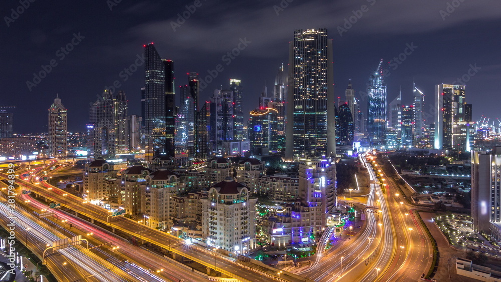 Aerial view on downtown and financial district in Dubai during all night timelapse, United Arab Emirates with skyscrapers and highways.